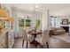 Open floorplan showcasing the dining area connecting to the cozy living room with fireplace at 13574 Se Whitman Ln, Covington, GA 30014