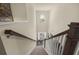 Staircase with neutral carpet, white risers and posts, and a window at the top of the stairs at 13574 Se Whitman Ln, Covington, GA 30014