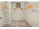 Spacious walk-in closet with carpet floor, white walls, and wire shelves for optimal storage at 13574 Se Whitman Ln, Covington, GA 30014