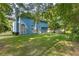 A large backyard features well-maintained grass and mature trees at 1901 Cherwell Dr, Riverdale, GA 30296