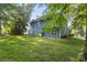 A large backyard features well-maintained grass and mature trees at 1901 Cherwell Dr, Riverdale, GA 30296
