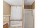 Bathroom featuring walk-in shower, tub, and tile surround at 1901 Cherwell Dr, Riverdale, GA 30296