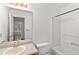 Bright bathroom features a shower-tub combo, single sink, and neutral tones at 1901 Cherwell Dr, Riverdale, GA 30296