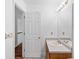 Neutral bathroom features a single sink vanity, a large mirror and lighting at 1901 Cherwell Dr, Riverdale, GA 30296