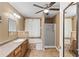 Neutral bathroom featuring a tub, walk-in shower, and a ceiling fan at 1901 Cherwell Dr, Riverdale, GA 30296