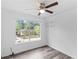 Bedroom with neutral walls, wood-look floors, ceiling fan and a large window at 1901 Cherwell Dr, Riverdale, GA 30296