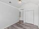 Bedroom with neutral walls, ceiling fan, wood-look floors, and closet at 1901 Cherwell Dr, Riverdale, GA 30296