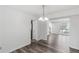 Bright dining room featuring modern wood floors, chandelier lighting, and an open layout to the living spaces at 1901 Cherwell Dr, Riverdale, GA 30296