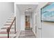 Light-filled entryway with hardwood floors, white walls, and staircase leading to the upper level at 1901 Cherwell Dr, Riverdale, GA 30296