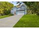 Charming two-story home with blue siding, an attached garage, and a well-manicured front lawn at 1901 Cherwell Dr, Riverdale, GA 30296