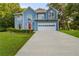Charming two-story home with blue siding, an attached garage, and a well-manicured front lawn at 1901 Cherwell Dr, Riverdale, GA 30296