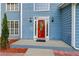 Eye-catching red front door with sidelights and decorative glass panel, complemented by modern lighting at 1901 Cherwell Dr, Riverdale, GA 30296