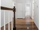 Hallway with hardwood flooring and white trim, leading to multiple rooms and storage spaces at 1901 Cherwell Dr, Riverdale, GA 30296