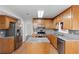 Well-equipped kitchen with stainless steel appliances, island and ample storage space in wood cabinets at 1901 Cherwell Dr, Riverdale, GA 30296