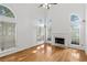 Bright living room boasting natural light, wood floors, a fireplace, and high ceilings at 1901 Cherwell Dr, Riverdale, GA 30296