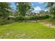 Backyard with lawn, retaining wall and mature trees surrounding the yard at 41 Spring Nw Ln, Atlanta, GA 30314