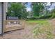 Wooden backyard deck with chairs, a small storage shed and a grassy yard at 41 Spring Nw Ln, Atlanta, GA 30314