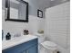 Charming bathroom features blue vanity, white wainscoting and shower curtain at 41 Spring Nw Ln, Atlanta, GA 30314