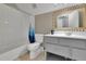 Cozy bathroom featuring a shower-tub combo, and a stylish gray vanity with modern fixtures at 41 Spring Nw Ln, Atlanta, GA 30314