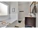 A bright bathroom featuring a soaking tub, a vanity, and a framed mirror at 41 Spring Nw Ln, Atlanta, GA 30314