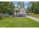 Charming light blue two-story home with a welcoming front porch and landscaped front yard at 41 Spring Nw Ln, Atlanta, GA 30314