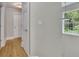 Hallway features neutral-colored walls, hardwood floors, and a bright window at 41 Spring Nw Ln, Atlanta, GA 30314