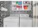 Functional laundry room with front-load washer and dryer and black and white wallpaper at 41 Spring Nw Ln, Atlanta, GA 30314