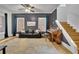 Inviting living room with hardwood floors, dark gray accent wall, and staircase to the second floor at 41 Spring Nw Ln, Atlanta, GA 30314