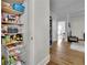 Pantry with open shelving, filled with groceries, and hardwood floors at 41 Spring Nw Ln, Atlanta, GA 30314