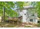 View of the backyard showing the home's siding, deck, and under-deck storage at 6230 Lillie Ln, Cumming, GA 30040
