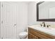 Bathroom featuring a wood vanity with a quartz countertop and decorative framed mirror at 6230 Lillie Ln, Cumming, GA 30040