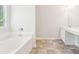 Bright bathroom with white cabinets, double vanity, and a separate tub at 6230 Lillie Ln, Cumming, GA 30040
