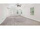 Spacious bedroom featuring a ceiling fan, neutral carpet, and ample natural light at 6230 Lillie Ln, Cumming, GA 30040