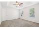Spacious carpeted bedroom featuring a trey ceiling with fan and natural light at 6230 Lillie Ln, Cumming, GA 30040
