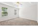 Bedroom featuring a ceiling fan, neutral carpet, and ample natural light at 6230 Lillie Ln, Cumming, GA 30040