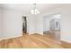 Bright dining room featuring an open layout, hardwood floors, and modern chandelier at 6230 Lillie Ln, Cumming, GA 30040