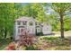 Charming two-story home with a manicured front yard, mature trees, and an attached two-car garage at 6230 Lillie Ln, Cumming, GA 30040
