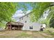 Back exterior of house with deck, showcasing a private backyard setting at 6230 Lillie Ln, Cumming, GA 30040