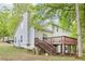 Two-story home featuring a deck with stairs leading down to the backyard at 6230 Lillie Ln, Cumming, GA 30040