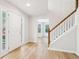 Welcoming foyer with a staircase, a front door with sidelights, and wood-look flooring at 6230 Lillie Ln, Cumming, GA 30040