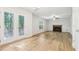 Bright living room with wood floors, a cozy fireplace, and access to the outdoors at 6230 Lillie Ln, Cumming, GA 30040