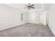 Main bedroom offering carpet, tray ceilings, ceiling fan, and neutral color palette at 6230 Lillie Ln, Cumming, GA 30040