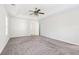 Spacious bedroom with plush carpet, a ceiling fan, and neutral-colored walls at 6230 Lillie Ln, Cumming, GA 30040