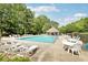 Community pool with lounge chairs and seating, perfect for relaxation and recreation at 6230 Lillie Ln, Cumming, GA 30040