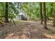 Large backyard with mature trees and room for activities at 135 Dunwick Ln, Mcdonough, GA 30253