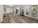 Open dining area featuring modern flooring and access to backyard and kitchen at 135 Dunwick Ln, Mcdonough, GA 30253
