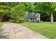 Quaint home with a long driveway and lush greenery offers a serene setting at 135 Dunwick Ln, Mcdonough, GA 30253