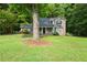 Charming two-story home features a welcoming front porch and well-maintained lawn at 135 Dunwick Ln, Mcdonough, GA 30253