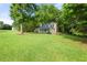 Beautifully landscaped front yard showcases a charming home nestled among mature trees at 135 Dunwick Ln, Mcdonough, GA 30253