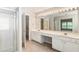 Bathroom with double sinks, large mirror with vanity lighting, and a glass shower at 144 Nocatee Trl, Woodstock, GA 30188